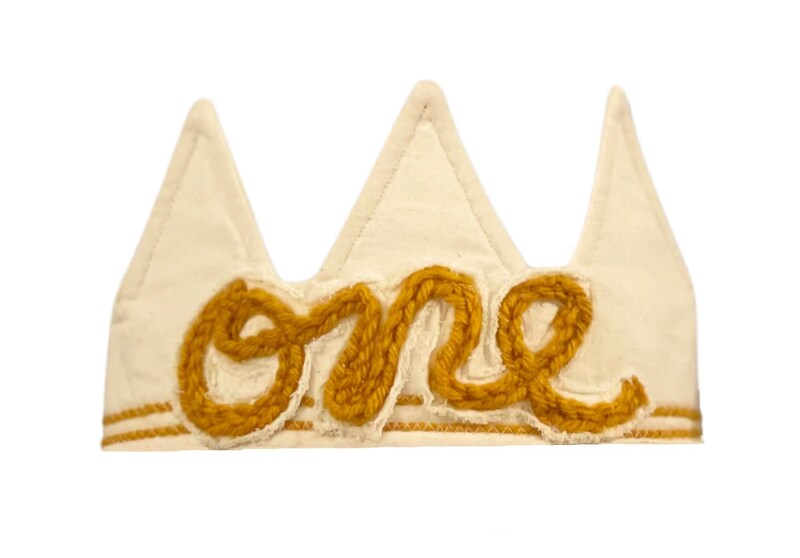 First Trip Around the Sun Birthday Crown, Mustard Gold Crochet Writing on Off-White Background Adjustable First Birthday Hat